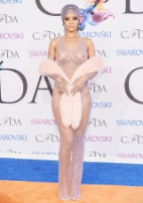 Rihanna in custom Adam Selman fishnet dress, gloves, and headscarf, all embellished with over 216,000 Swarovski crystals.